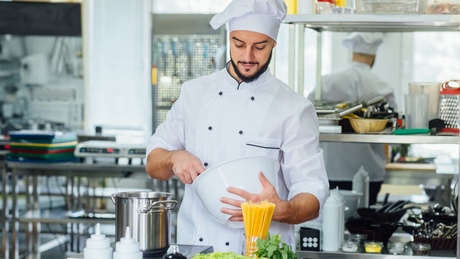 Cooking food, profession and people concept, happy male chef cook at restaurant kitchen.